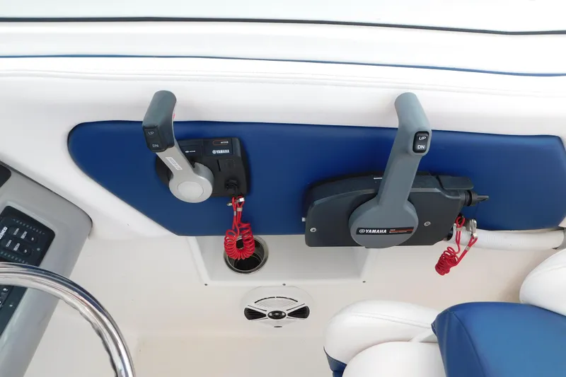 Slide: The Image of 2018 Robalo R247 Dual Console boat controls with Yamaha throttle levers and safety lanyards. - 32