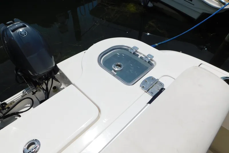 Slide: The Image of 2018 Robalo R247 Dual Console boat with Yamaha outboard motor, featuring a sleek deck design. - 11