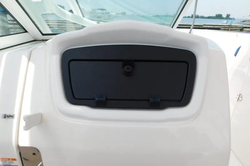 Slide: The Image of 2018 Robalo R247 Dual Console boat dashboard with storage compartment. - 39