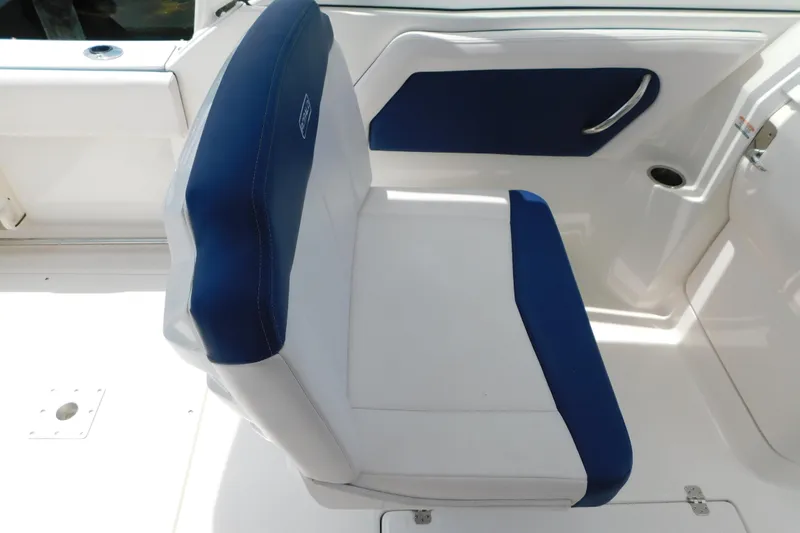 Slide: The Image of 2018 Robalo R247 Dual Console boat seat with blue and white upholstery. - 35
