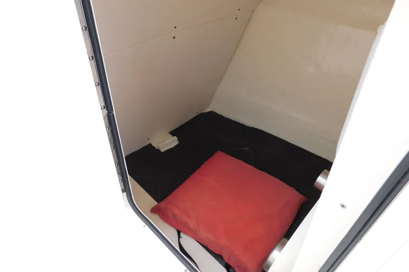 Slide: The Image of Interior cabin of 2018 Robalo R247 Dual Console boat with red cushion. - 52