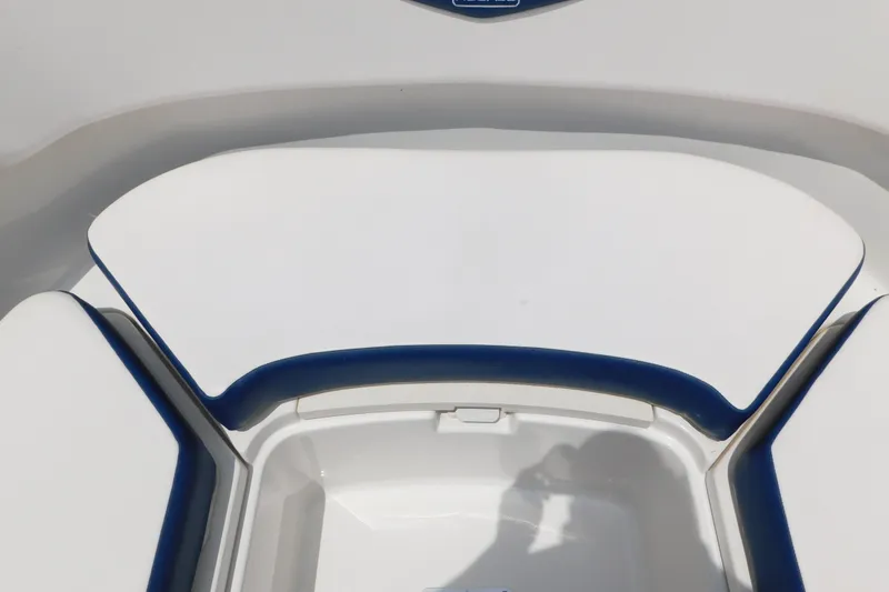 Slide: The Image of 2018 Robalo R247 Dual Console boat seating area with white and blue upholstery. - 56