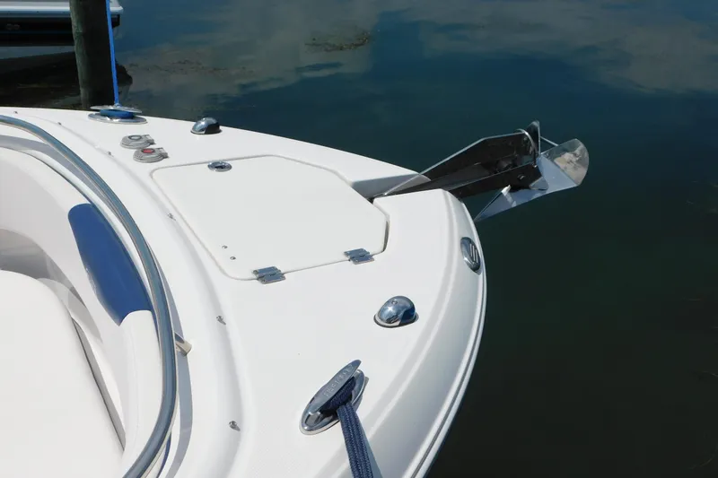 Slide: The Image of 2018 Robalo R247 Dual Console boat bow with anchor and sleek design. - 8