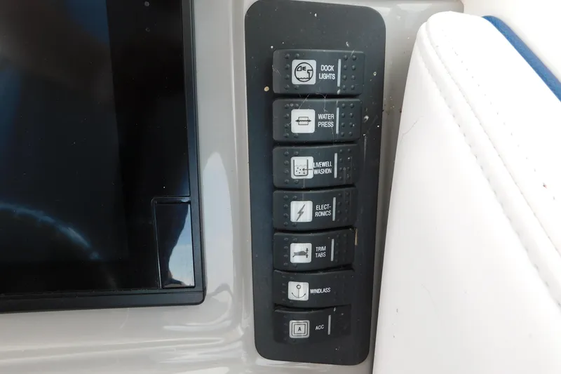Slide: The Image of Control panel of a 2018 Robalo R247 Dual Console boat with labeled switches. - 41