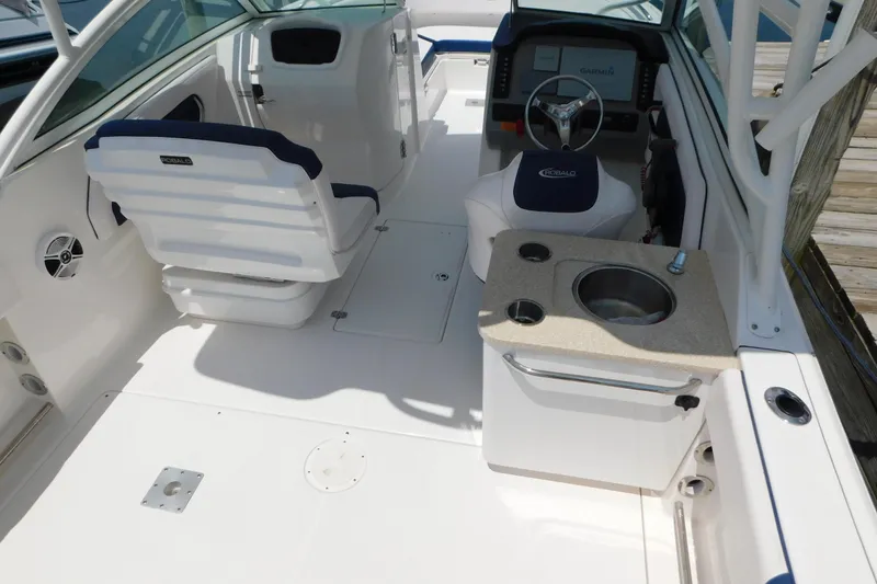 Slide: The Image of 2018 Robalo R247 Dual Console boat interior with helm, seating, and sink station. - 13