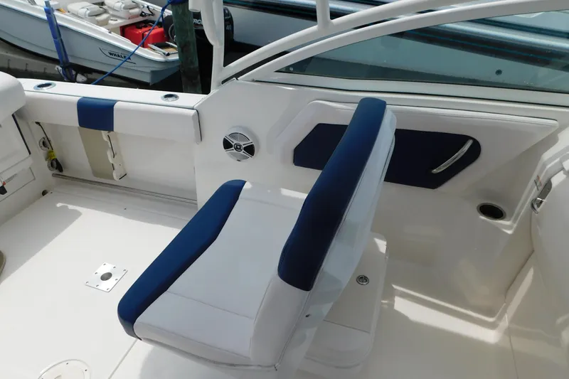 Slide: The Image of 2018 Robalo R247 Dual Console boat interior with blue and white seating. - 37