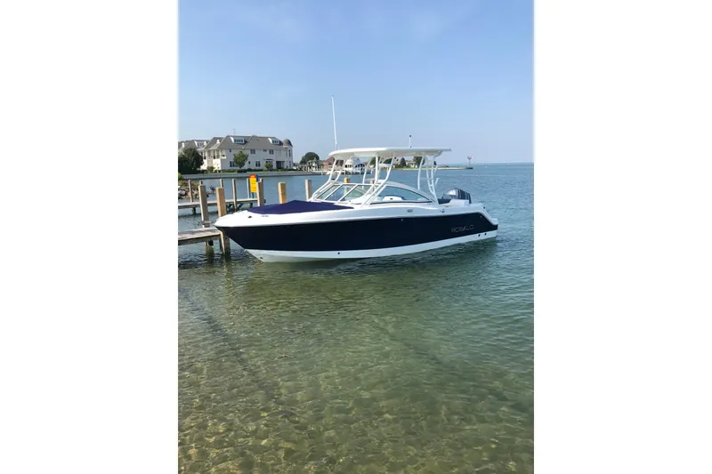 Slide: The Image of 2018 Robalo R247 Dual Console boat docked in clear, calm waters. - 74