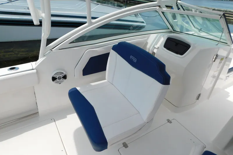 Slide: The Image of 2018 Robalo R247 Dual Console boat interior with blue and white seating. - 36
