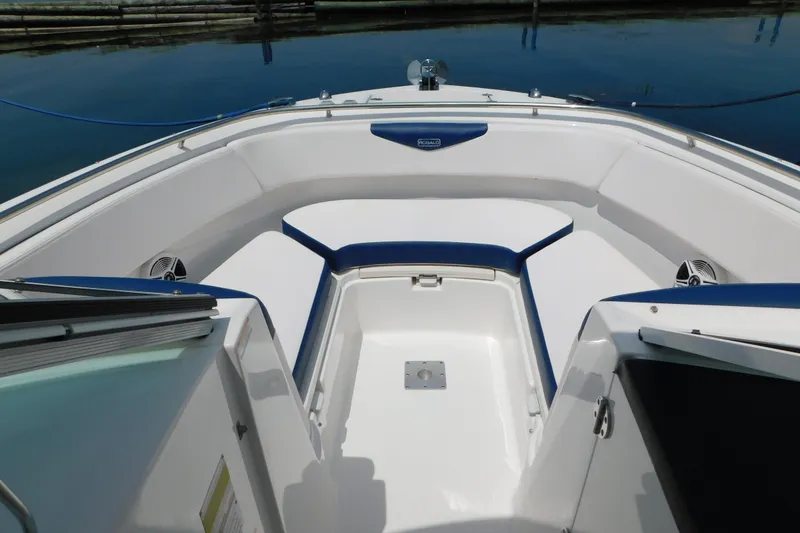 Slide: The Image of 2018 Robalo R247 Dual Console boat interior with white and blue seating. - 53