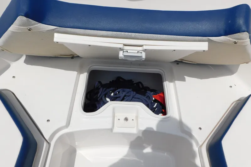 Slide: The Image of 2018 Robalo R247 Dual Console boat storage compartment with ropes and gear. - 57
