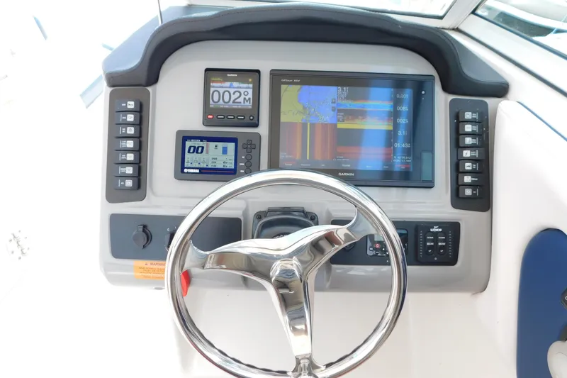 Slide: The Image of 2018 Robalo R247 Dual Console helm with Garmin navigation and Yamaha controls. - 28