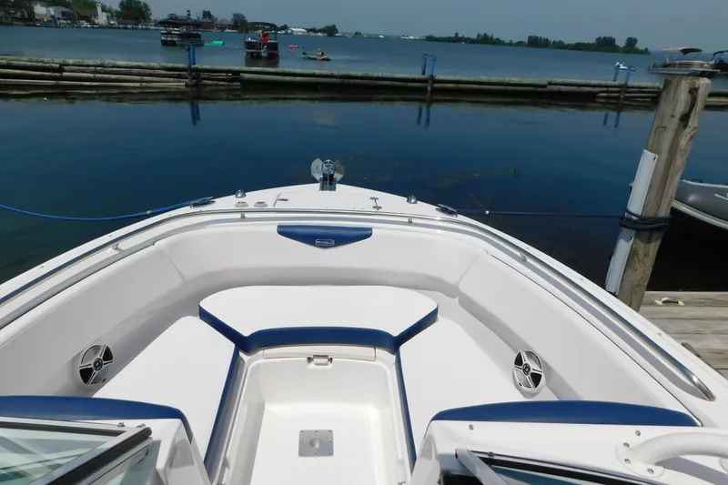 Slide: The Image of 2018 Robalo R247 Dual Console boat docked by a serene lake. - 68