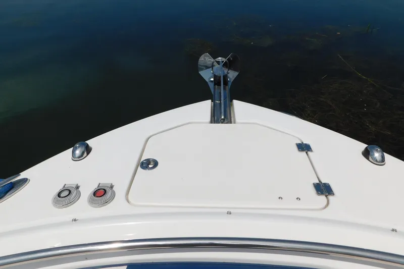 Slide: The Image of 2018 Robalo R247 Dual Console boat bow with anchor and hatch. - 60