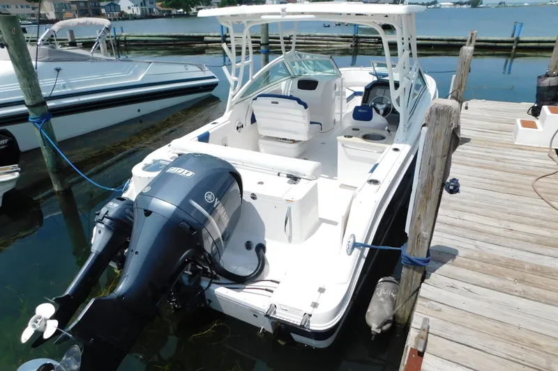 Slide: The Image of 2018 Robalo R247 Dual Console boat docked with Yamaha outboard motor. - 5