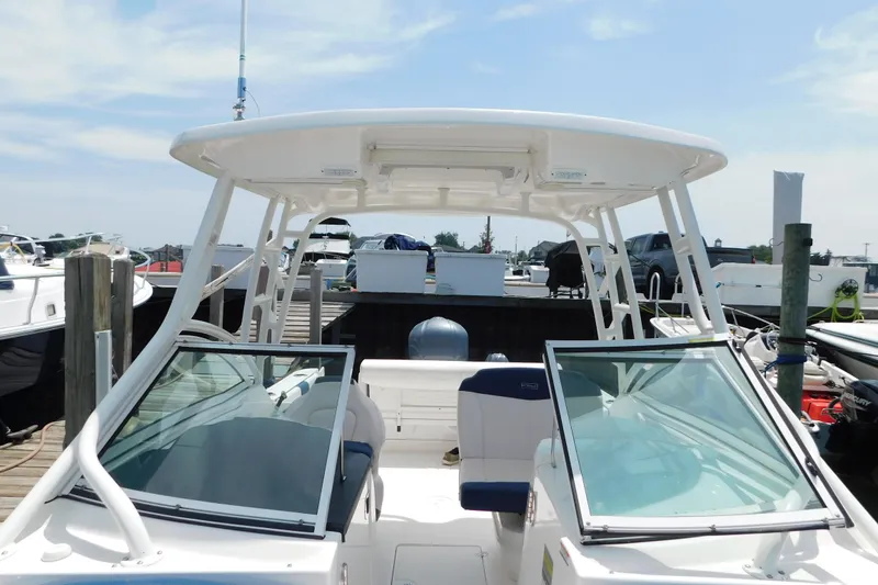 Slide: The Image of 2018 Robalo R247 Dual Console boat docked at marina under clear sky. - 64