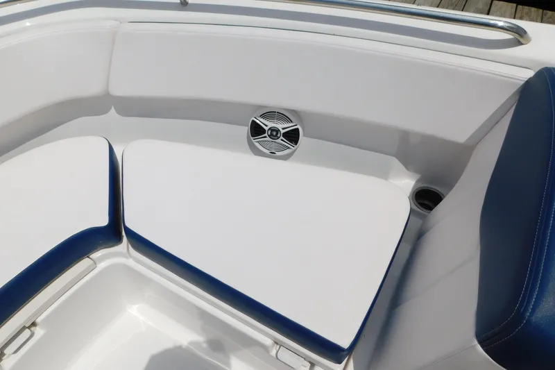 Slide: The Image of 2018 Robalo R247 Dual Console boat interior with white and blue seating. - 54