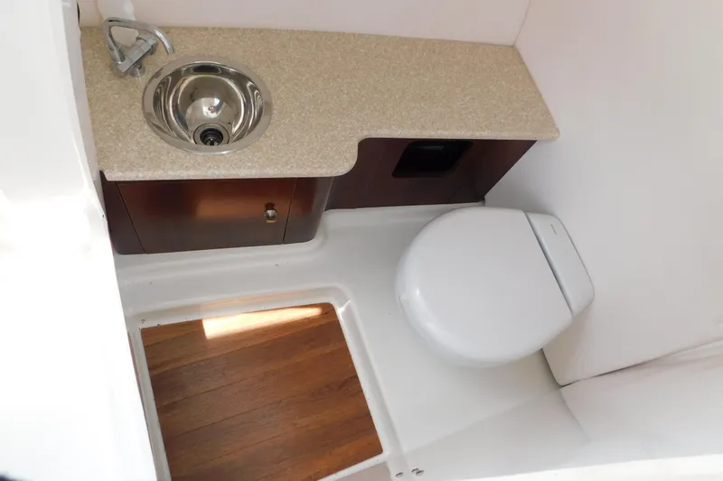 Slide: The Image of 2018 Robalo R247 Dual Console boat bathroom with sink and toilet. - 47