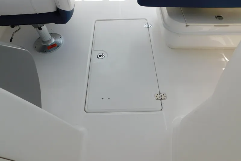 Slide: The Image of 2018 Robalo R247 Dual Console boat interior with storage compartment and seating. - 65