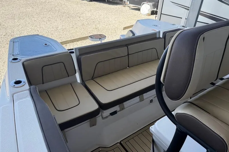 Slide: The Image of 2024 Yamaha Boats 255 FSH Sport H interior seating with beige and gray upholstery. - 16