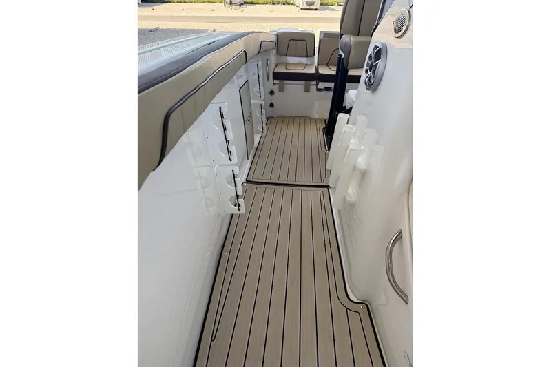 Slide: The Image of 2024 Yamaha Boats 255 FSH Sport H interior with sleek deck and storage compartments. - 13