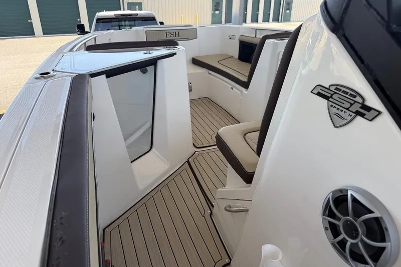 Slide: The Image of 2024 Yamaha Boats 255 FSH Sport H interior with seating and speaker detail. - 9