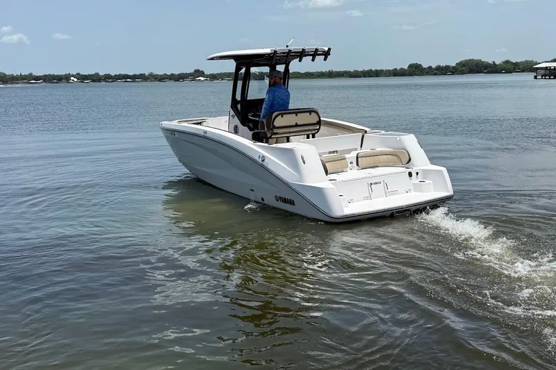 Slide: The Image of 2024 Yamaha Boats 255 FSH Sport H cruising on calm waters. - 5
