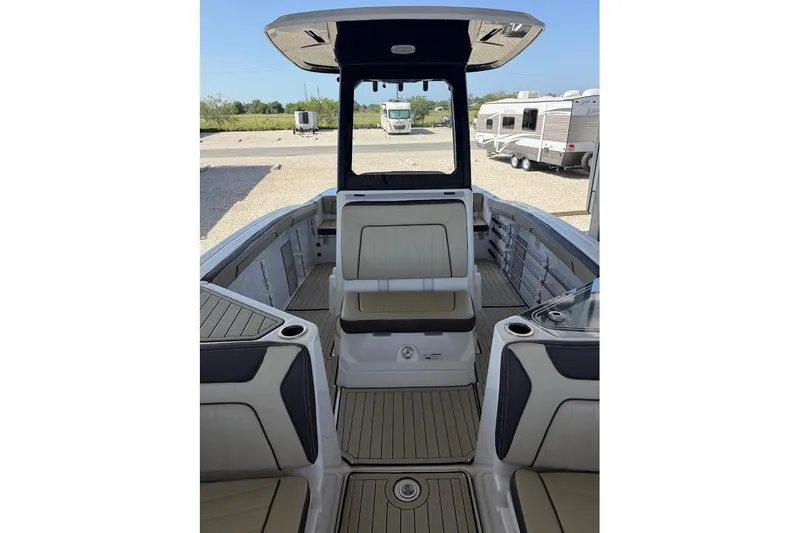 Slide: The Image of 2024 Yamaha Boats 255 FSH Sport H interior with seating and console. - 11