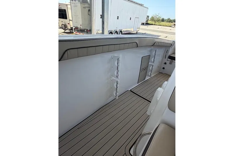 Slide: The Image of 2024 Yamaha Boats 255 FSH Sport H interior with sleek seating and storage compartments. - 23