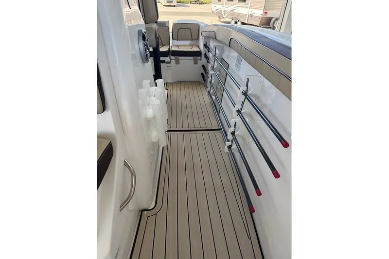 Slide: The Image of 2024 Yamaha Boats 255 FSH Sport H interior with rod holders and seating. - 12