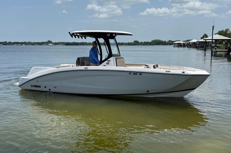 The Image of 2024 Yamaha Boats 255 FSH Sport H on calm water, side view. - 1