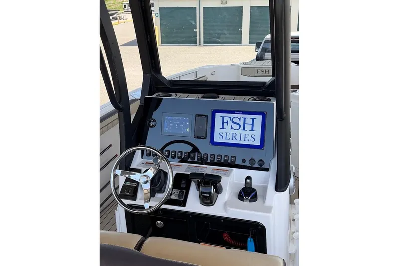 Slide: The Image of 2024 Yamaha Boats 255 FSH Sport H dashboard with steering wheel and control panel. - 19