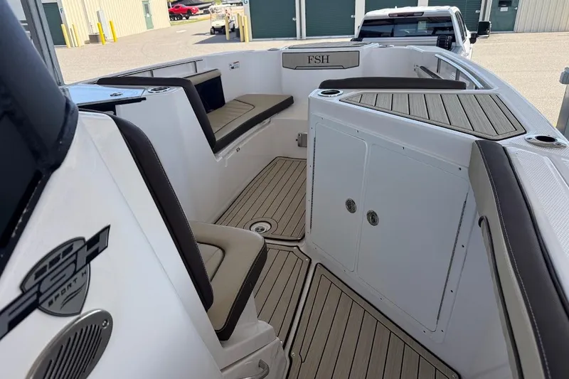 Slide: The Image of 2024 Yamaha Boats 255 FSH Sport H interior with seating and storage compartments. - 8