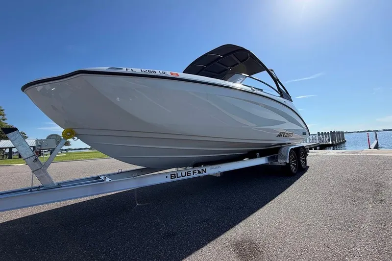 Slide: The Image of 2025 Yamaha Boats AR250 on trailer by the water, sunny day. - 32