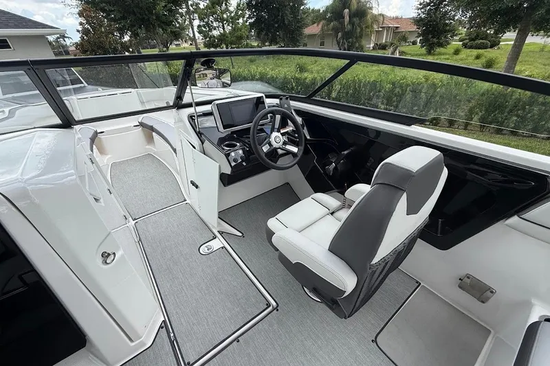 Slide: The Image of 2025 Yamaha Boats AR250 cockpit with modern steering and navigation system. - 8