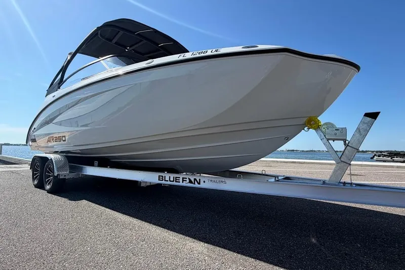 Slide: The Image of 2025 Yamaha Boats AR250 on trailer by waterfront, under clear blue sky. - 35