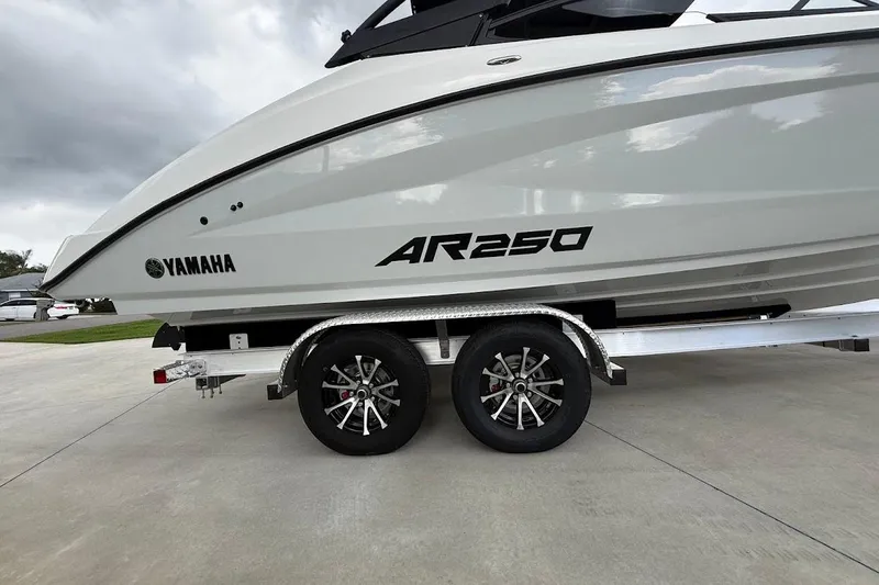 Slide: The Image of 2025 Yamaha AR250 boat on trailer, side view with logo visible. - 30