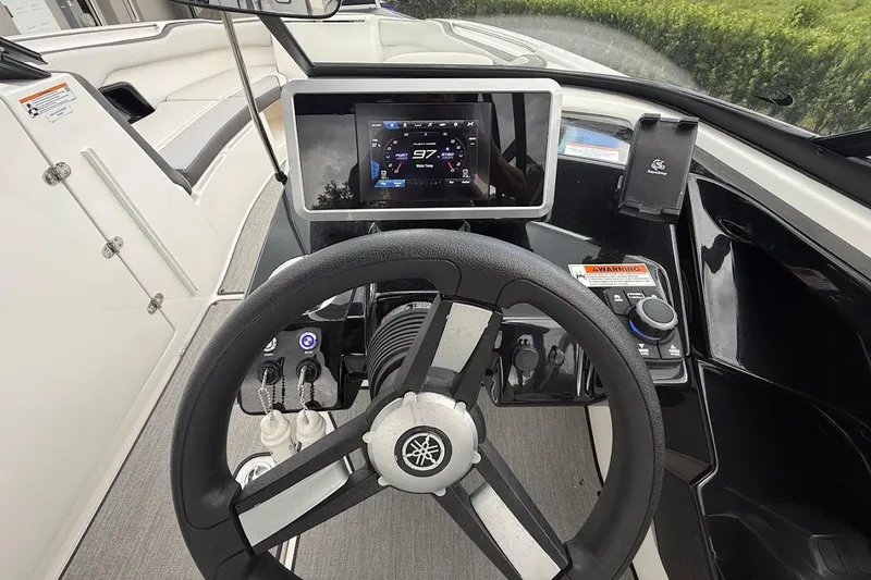 Slide: The Image of 2025 Yamaha Boats AR250 dashboard with steering wheel and digital display. - 19