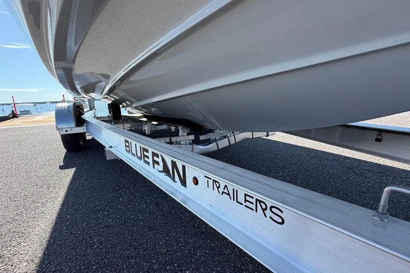 Slide: The Image of 2025 Yamaha Boats AR250 on Bluefin trailer, parked near waterfront. - 36