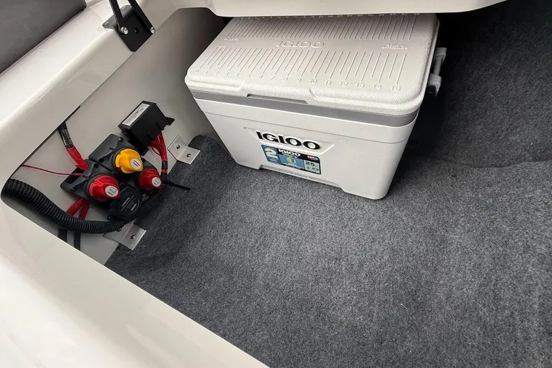 Slide: The Image of Interior of 2025 Yamaha AR250 boat with Igloo cooler and electrical components. - 17