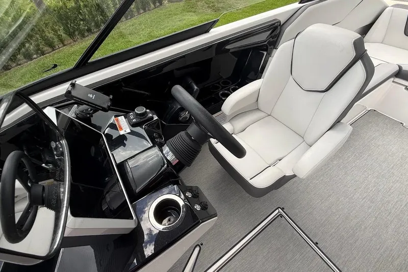 Slide: The Image of 2025 Yamaha Boats AR250 cockpit with sleek steering and modern seating design. - 12