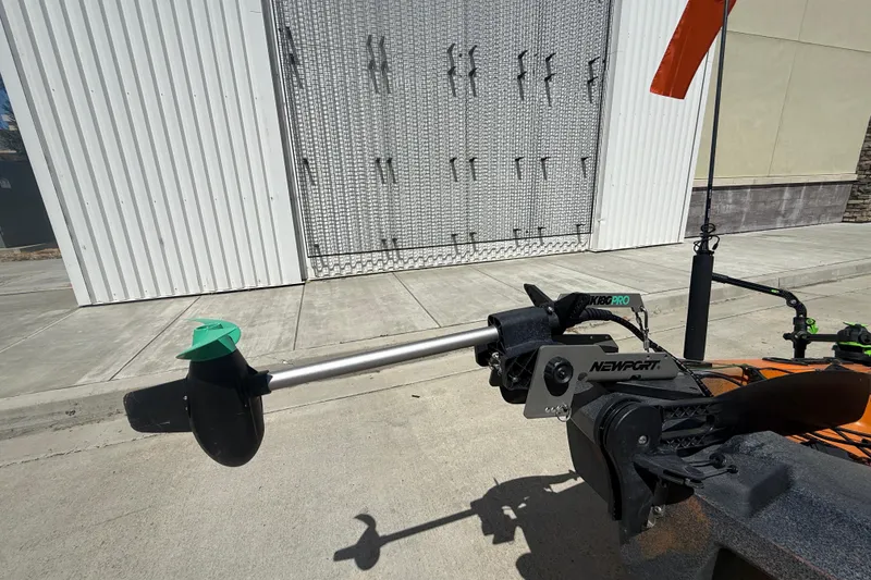 Slide: The Image of OldTown Sportsman PDL 106 kayak with Newport motor, 2023 model, parked on concrete. - 10