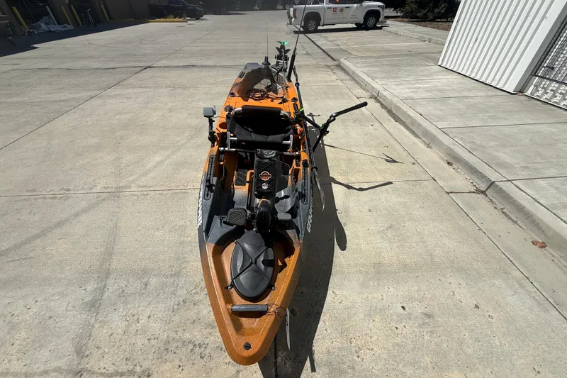 Slide: The Image of 2023 OldTown Sportsman PDL 106 kayak on concrete surface, equipped for fishing. - 8