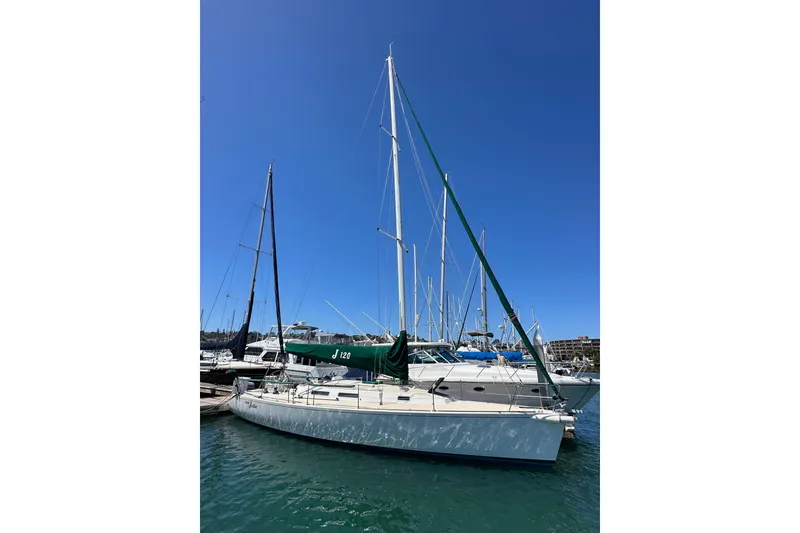 Slide: The Image of 1996 J Boats J/120 sailboat docked in a marina under clear blue skies. - 2