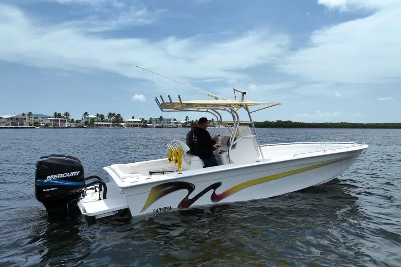 Slide: The Image of 2004 Carrera Boats 27 CC Open on water, featuring Mercury outboard engine. - 4
