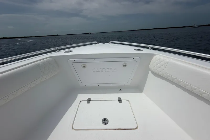 Slide: The Image of 2004 Carrera Boats 27 CC Open, white interior, on calm water under cloudy sky. - 12