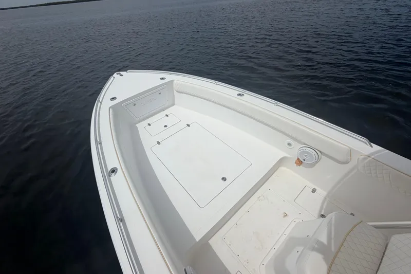 Slide: The Image of 2004 Carrera Boats 27 CC Open, white deck, on calm water. - 11