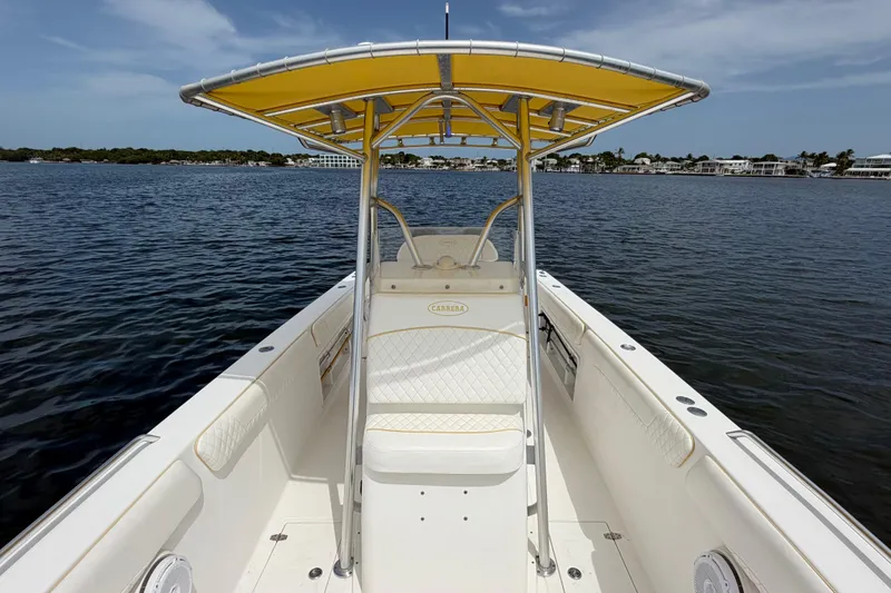 Slide: The Image of 2004 Carrera Boats 27 CC Open with yellow canopy on calm water. - 15