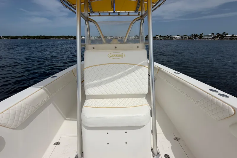 Slide: The Image of 2004 Carrera Boats 27 CC Open with white seating, on calm water. - 16