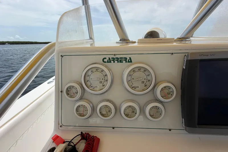 Slide: The Image of Dashboard of a 2004 Carrera Boats 27 CC Open with gauges and GPS display. - 26