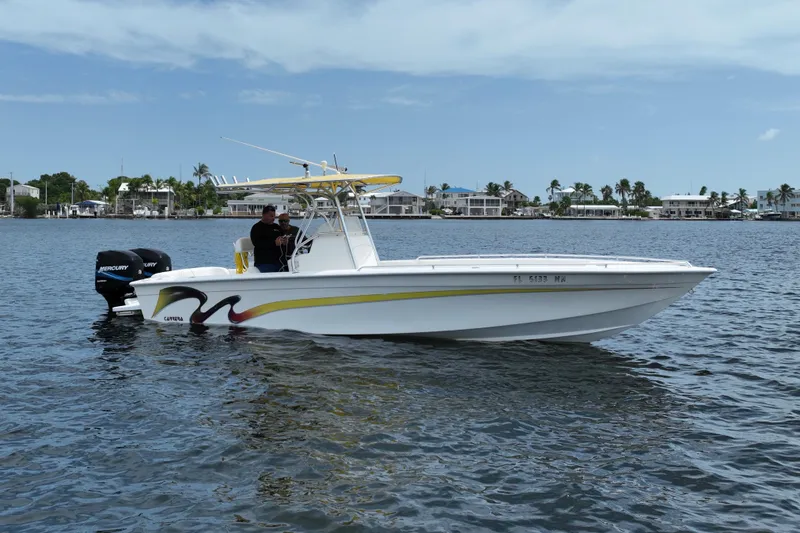 The Image of 2004 Carrera Boats 27 CC Open on water, featuring dual Mercury engines. - 1